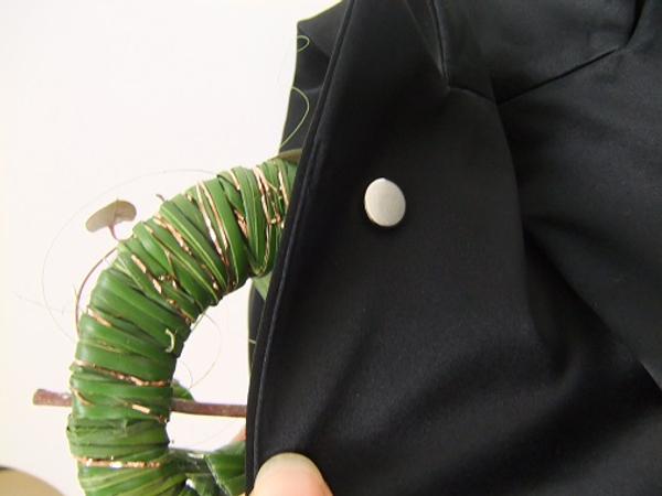 Place the corsage on the jacket lapel