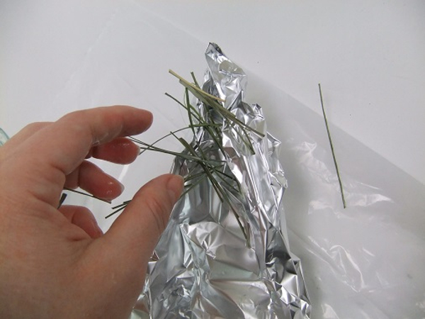 Scatter the glue soaked strands over the foil shape