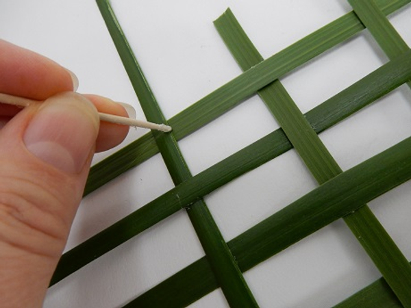 Secure the palm leaves with a tiny drop of glue