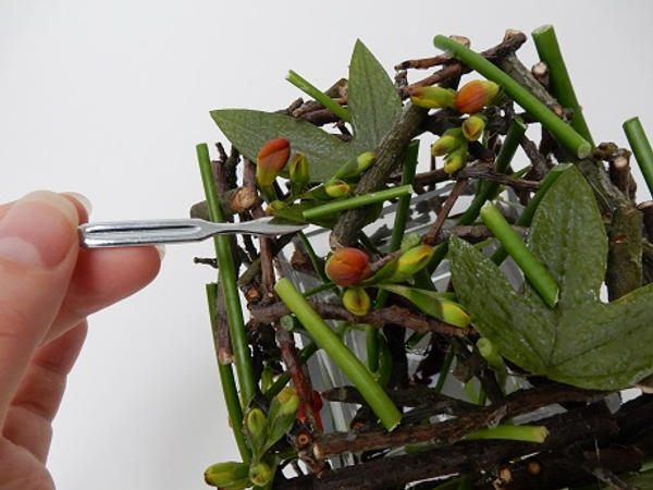 It is now easy to weave the dried foliage through the twigs in the design