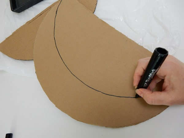 Draw the crescent shape on the cardboard