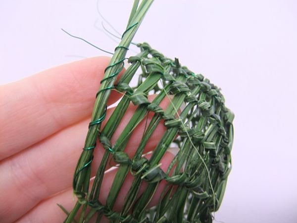 Fold the strands of grass and wire to the side and wrap the next wire around the strands