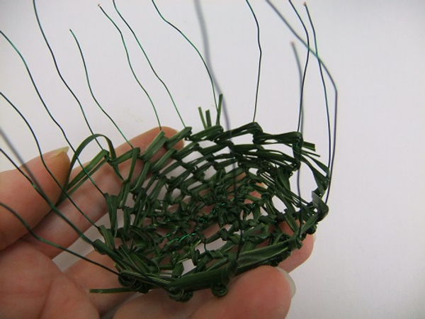 Fold the wires up and continue to wrap strands of grass to create the sides