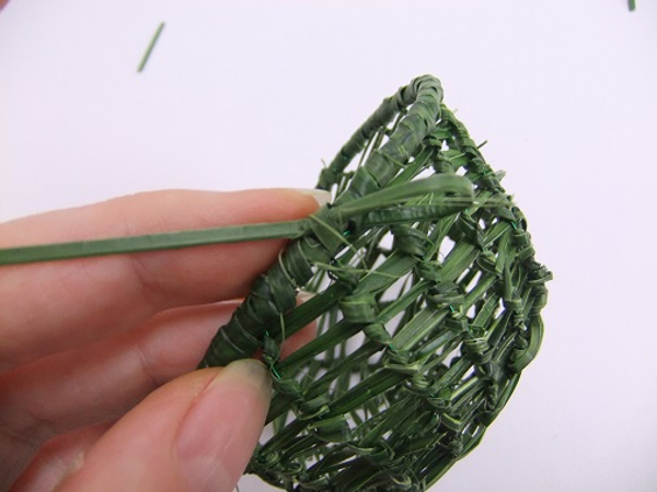 Knot the strand of grass on itself and cut away any loose pieces
