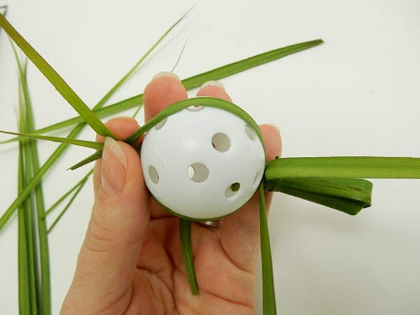 Fold the palm leaf over the ball and gather at the top