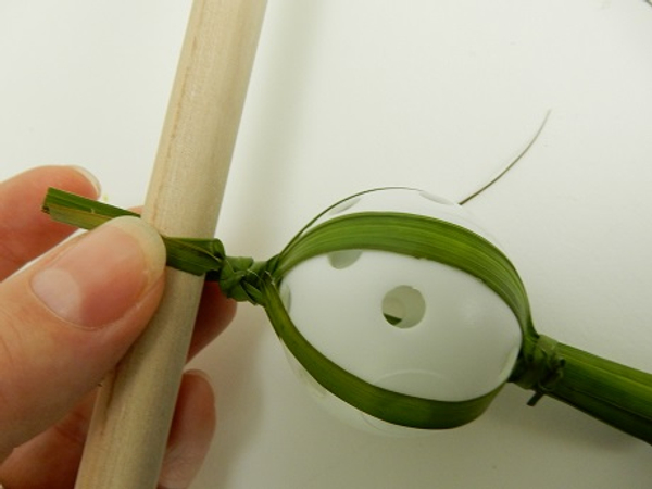 Split the left over strands of palm and wrap around a dowel