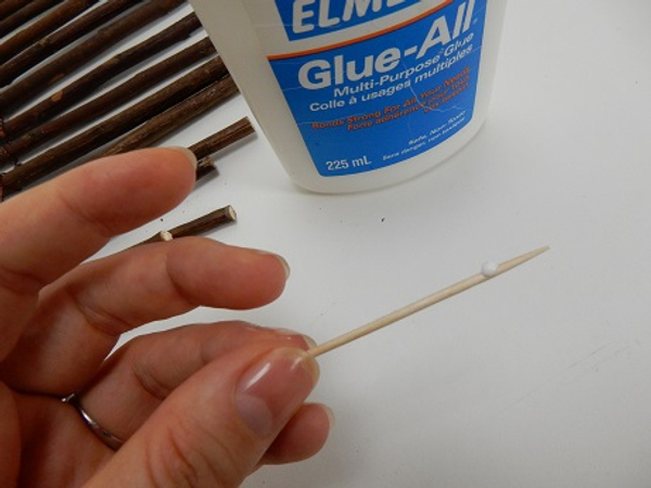Place a small drop of wood glue on a thin bamboo skewer.