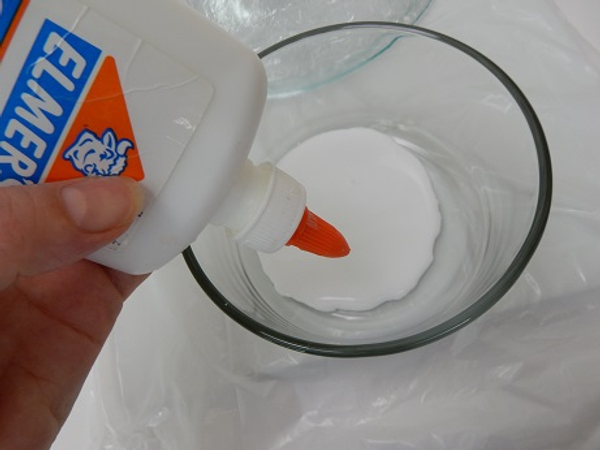 Pour some clear drying wood glue into a bowl.