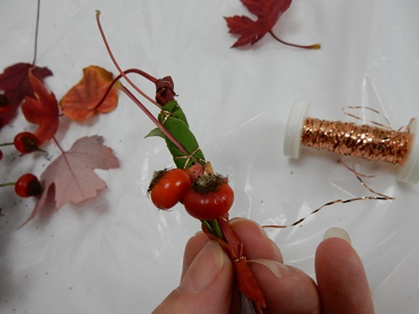As you add leaves add a few rose hips into the garland