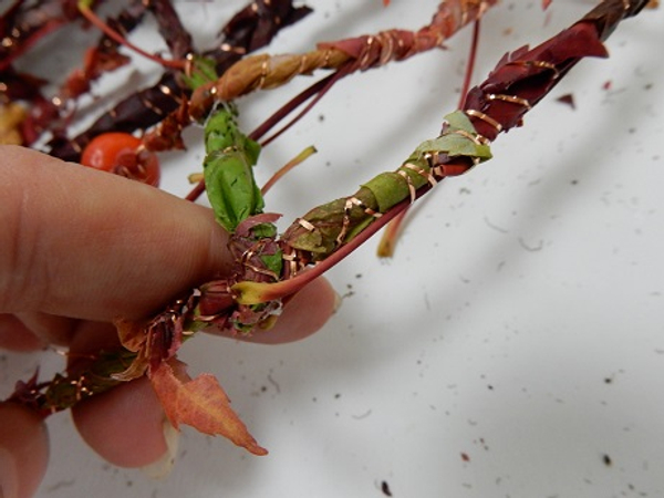 Fold the strand over the garland and secure with wire