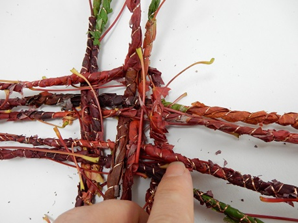 Weave the garland over the first two and under the next two strands