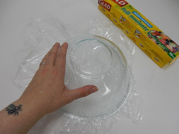 Cover a bowl with cling wrap