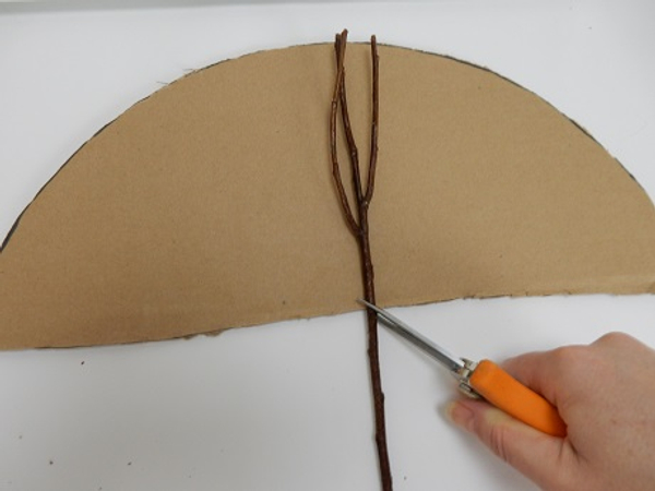 Place the cardboard on a flat working surface