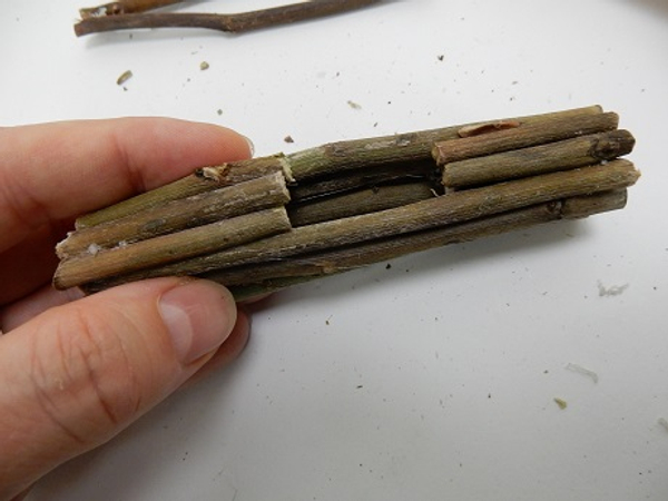 Glue twigs on both ends to complete the hollow bundle