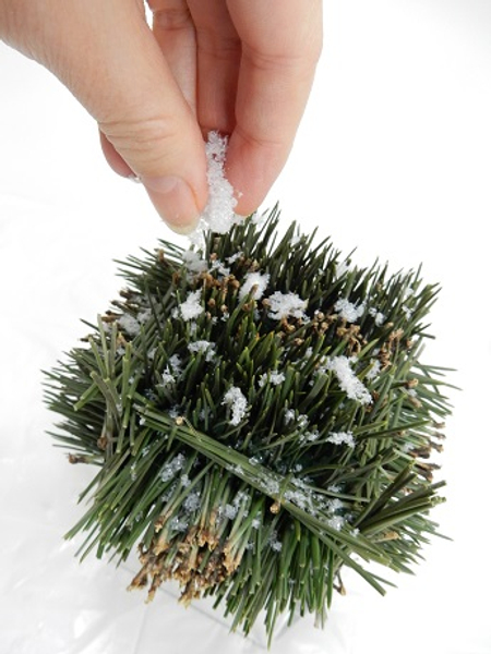 Lightly dusting the entire cube with artificial snow