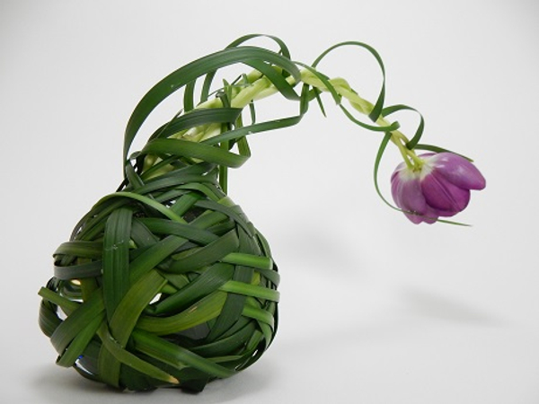 Cover the glass bubble shaped vase with woven grass