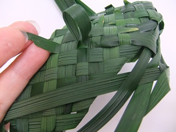 Cut the leaf to a sharp angle to make it easier to insert back into the weave of the sole