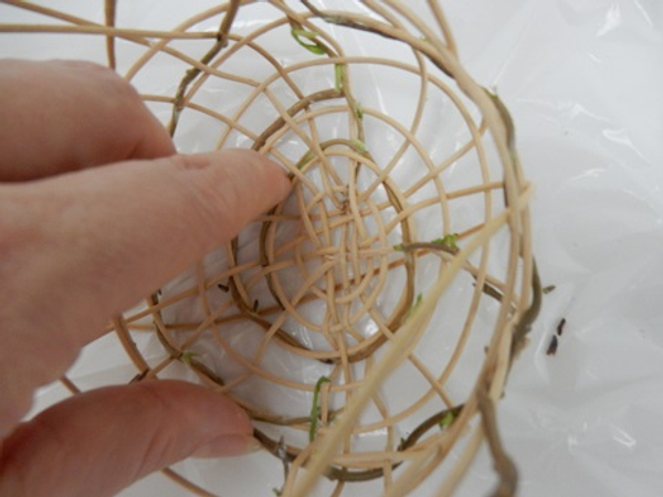 Carefully wiggle the strands at the base to seprate it and spread it around the sides of the nest