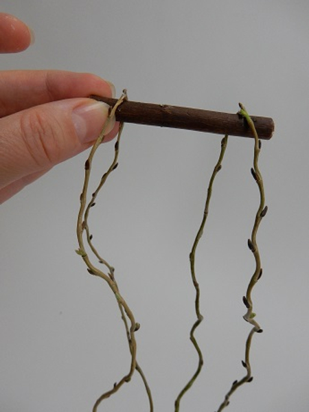 Fold another twig in half and rest it over on the other side of the twig