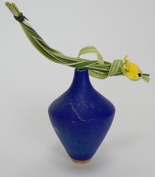 Orchid and grass vase