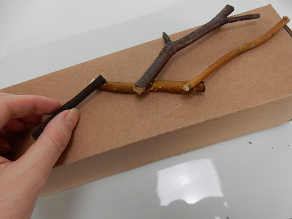 Follow the box shape and glue twig after twig.