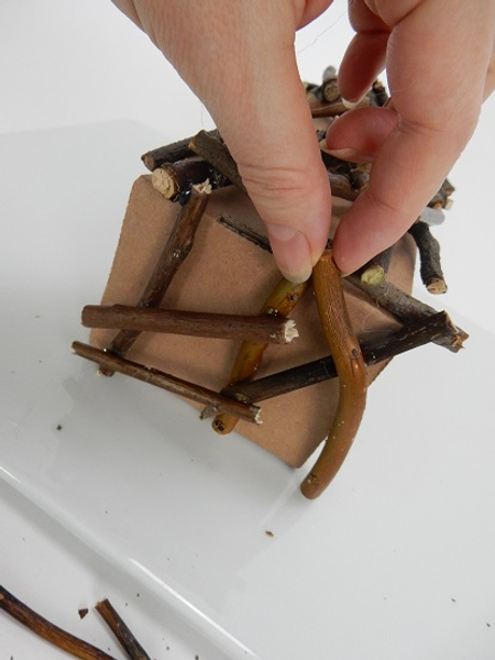 Turn the box and glue twigs to follow the side shape of the box Turn the box and glue twigs to follow the side shape of the box