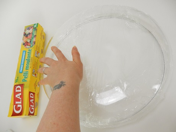 Cover a disk shaped bowl with wrap to protect it