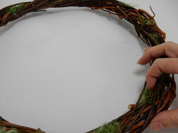 Soften the overall look of the wreath by filling the gaps with wool