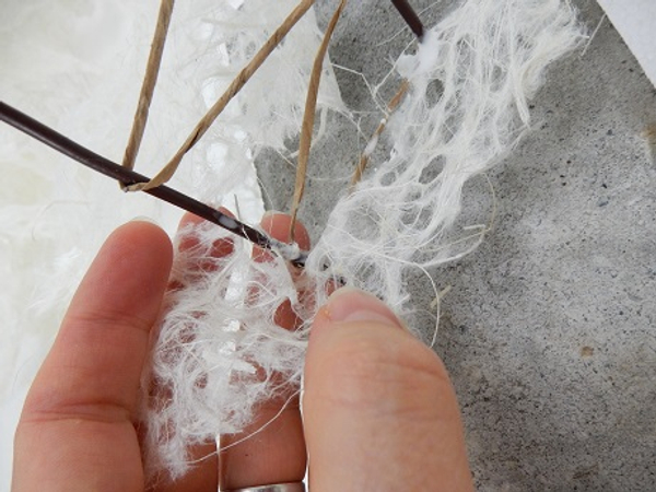 Start to wrap the paper garland following the wire shape