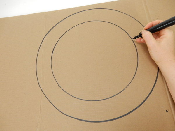 Draw two circles on a sturdy cardboard sheet. Draw two circles on a sturdy cardboard sheet.