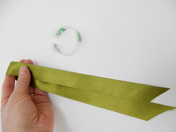 Fold the ribbon in half to get the middle point