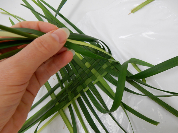 Fold the sides up and continue the weaving pattern