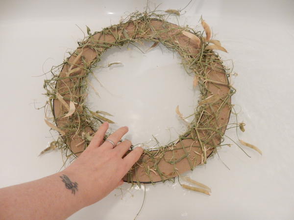 To remove the cardboard soak the wreath in a water bath To remove the cardboard soak the wreath in a water bath