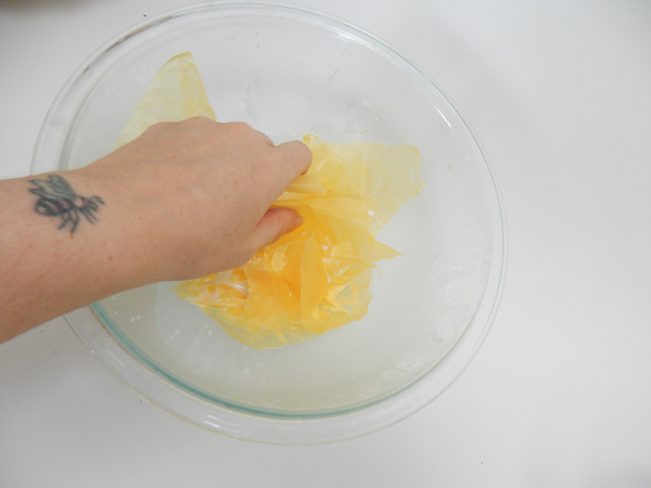 Soak yellow tissue paper in thinned wood glue