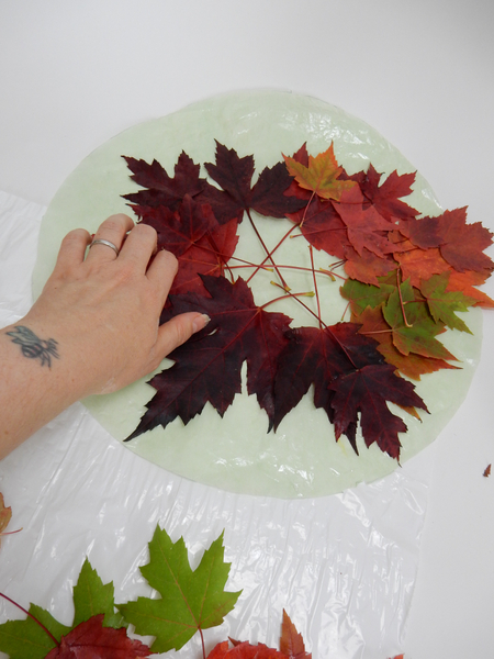 Glue the leaves to the paper leaving the middle section empty