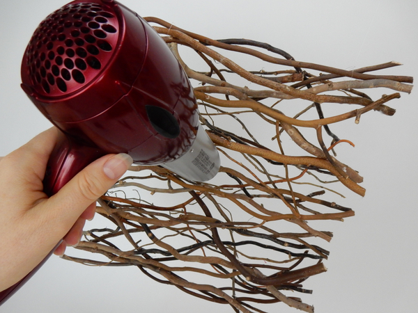 Blow any hot glue strands away with a hairdryer set on a warm setting.  
