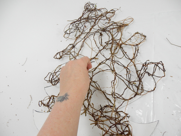 Weave in fresh vine to fill in any gaps to complete the Christmas tree shape