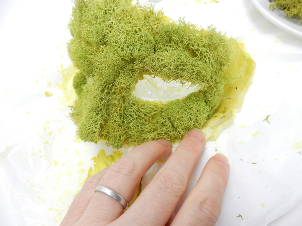 Build up the facial features from torn bits of moss