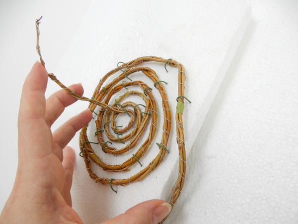 And spiral the willow twig garland back in