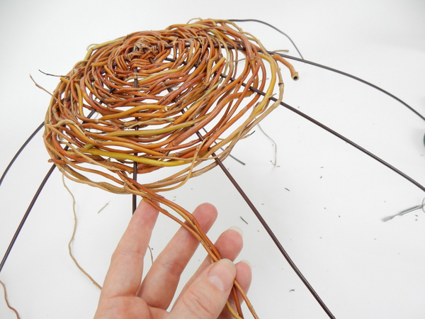  Weave thin willow stems through the wires in to create a dense spiral around the binding point.
