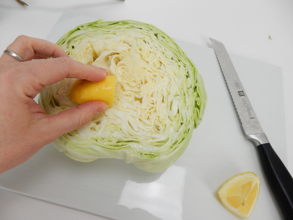 Cut open a lemon and rub it over the cabbage to prevent it from going brown