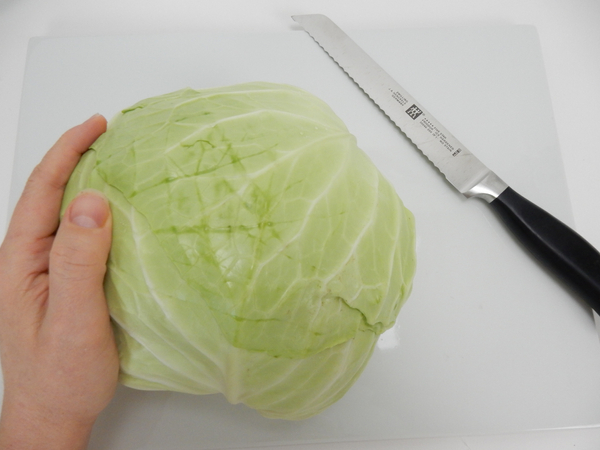 Let the cabbage rest on a working surface to find it's natural balance point