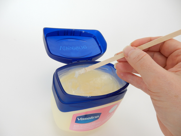 Scoop up a small bit of baby petroleum jelly on a spreader