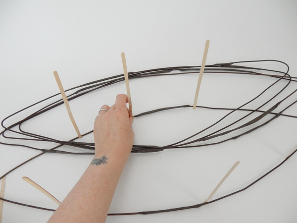 Glue in bamboo sticks to separate the wire into levels.