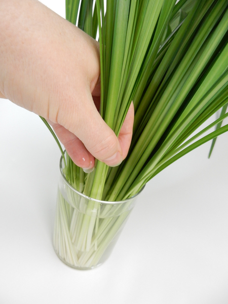 Keep adding bundles of grass to almost fill the vase