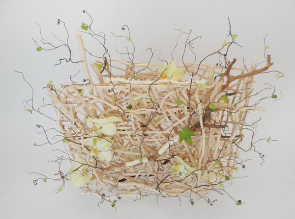 Phalaenopsis orchids, ivy, willow and grape vine tendrils on a popsicle stick armature floral art design