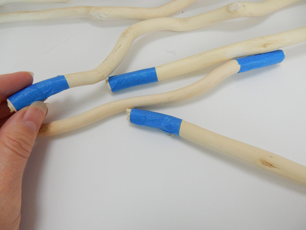 Wrap painters tape around the bottom of four willow sticks as spacers for the armature feet