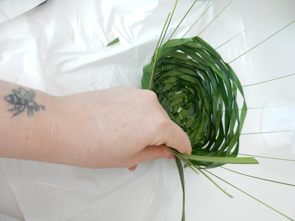 Weave around and around creating the bowl of the hat