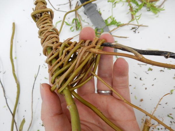 Do the same at the top weaving around the stems down to the wider looped side