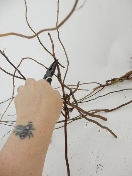 Twist the wire around the twigs in a figure eight to secure Twist the wire around the twigs in a figure eight to secure